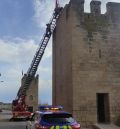 Los bomberos retiran un mástil de un torreón de Muro de Santiago de Alcañiz