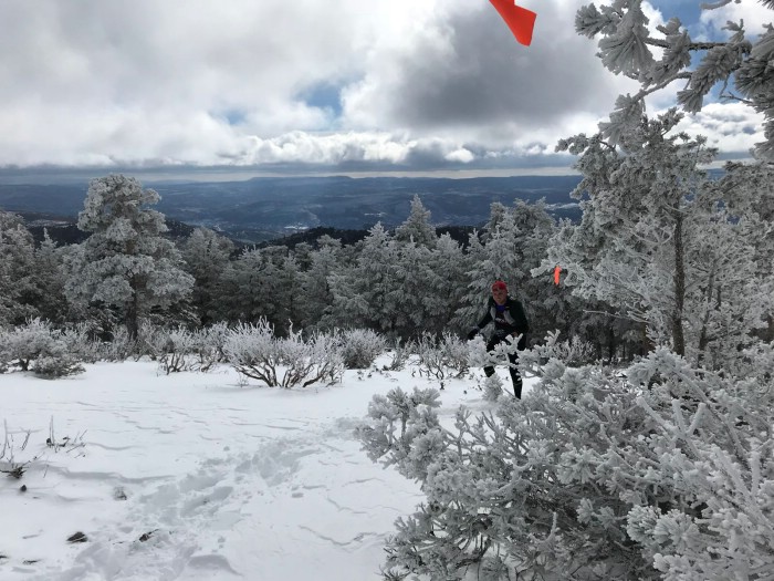 Un corredor progresa en una ladera nevada