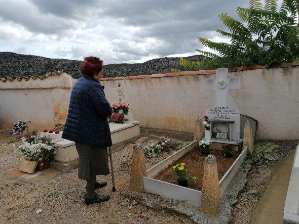 Una mujer junto a una tumba, en el cementerio de Berge